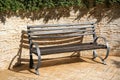 Beautiful wooden bench near brick wall on pavement outdoors Royalty Free Stock Photo