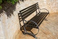 Beautiful wooden bench near brick wall on pavement outdoors Royalty Free Stock Photo