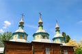 Beautiful wooden church against blue sky. Stunning landscape view in Pereyaslav-Khmelnitsky Museum of Folk Architecture and Life