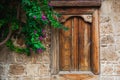 Beautiful wooden closed window in stone wall