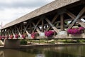 Wooden Covered Bridge with Colorful Flowers over the DuPage River along the Naperville Riverwalk in Suburban Naperville Illinois d Royalty Free Stock Photo