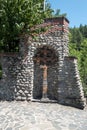 Beautiful wooden cross placed below an arch stone wall Royalty Free Stock Photo