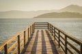 Beautiful wooden dock in pond overlooking mountains, quiet view Royalty Free Stock Photo