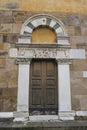 Beautiful wooden door of the Church Chiesa di San Salvatore in Lucca, Tuscany, Italy Royalty Free Stock Photo