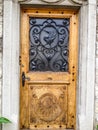 Beautiful Wooden door with Swan Iron Wrought Pattern on old house in Gruyere village, Fribourg canton, Switzerland, Europe