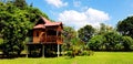 Beautiful wooden house or home with green tree and Blue sky and clouds for background Royalty Free Stock Photo