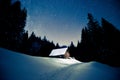 Beautiful wooden house in the winter forest under the stars Royalty Free Stock Photo