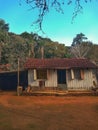 beautiful wooden hut on a farm with a red earth floor on a sunny day with a blue sky Royalty Free Stock Photo