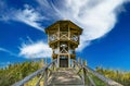 Beautiful wooden look-out tower with picnic spot on hill in rural dutch landscape along hiking and cycle trail - Heeskijk near