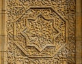 Beautiful wooden octagonal star rosette with floral pattern - details of medieval Karakhanid `s tomb door in Uzgen,Osh Region, Ky