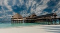 beautiful wooden pier with thatched huts in ocean