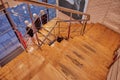 Beautiful wooden stairs with metal railing and three mannequins in shop window at the bottom of the street in Toledo