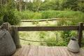 Beautiful wooden terrace with tin and fishing net near swamp Royalty Free Stock Photo