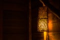 Beautiful wooden wall lamp hanging on wood log over the bed in the cottage at countryside. Royalty Free Stock Photo