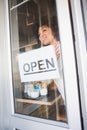 Beautiful worker showing open sign