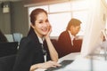 Beautiful working women portrait looking camera happy smile in office with co worker