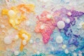 Beautiful world map created with colorful exploding soap bubbles against a pastel background Royalty Free Stock Photo