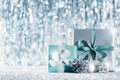 Beautiful wrapped christmas gifts and ornaments with defocused christmas lights in the background. Christmas backdrop. Royalty Free Stock Photo