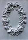 Beautiful wreath with flowers, berries and leaves carved into the side of headstone