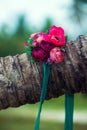 A beautiful wreath of flowers lies on a palm tree