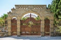 Beautiful wrought-iron gates in brick arch on the