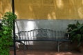 Beautiful Wrought Iron Outdoor Bench against Mediterranean Bisque color wal