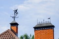 A beautiful wrought iron weathercock on the roof of the house. Royalty Free Stock Photo