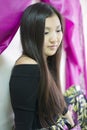 Beautiful Yakut the girl sitting on the bed. Royalty Free Stock Photo