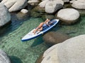 Beautiful yang lady relaxes on the paddle board