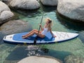 Beautiful yang lady relaxes on the paddle board