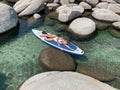 Beautiful yang lady relaxes on the paddle board