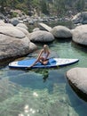 Beautiful yang lady relaxes on the paddle board