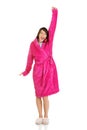 Beautiful yawning woman in pink bathrobe. Royalty Free Stock Photo