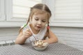 Child eats ice cream with a spoon