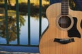 Beautiful yellow acoustic guitar on the bridge. Royalty Free Stock Photo