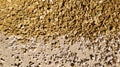 Beautiful yellow-beige gravel in bright. A place for text. Background. Texture. Yellow and white raffia lie side by side