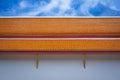 Beautiful yellow ceramic roof tiles on white building of temple exterior architecture with blue sky Royalty Free Stock Photo