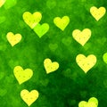 Beautiful yellow damaged overlapping hearts on bright fresh natural green background