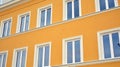 Beautiful yellow facade, restored building exterior in old town. Royalty Free Stock Photo