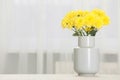 Beautiful yellow flowers in vase on table at home, space for text Royalty Free Stock Photo