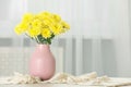 Beautiful yellow flowers in vase on table at home, space for text Royalty Free Stock Photo