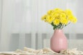 Beautiful yellow flowers in vase on table at home, space for text Royalty Free Stock Photo
