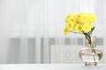 Beautiful yellow flowers in vase on table at home, space for text Royalty Free Stock Photo