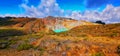 Beautiful yellow mountain with blue lake and white smoke and fantastic green forest nature Royalty Free Stock Photo
