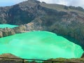 Beautiful yellow mountain with blue lake and white smoke and fantastic green forest nature Royalty Free Stock Photo