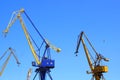 Beautiful yellow naval cranes, standing out against the azure blue sky of the port of Piraeus, near Athens in Greece Royalty Free Stock Photo