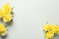 Beautiful yellow roses on light grey background, flat lay. Space for text Royalty Free Stock Photo