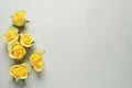 Beautiful yellow roses on light grey background, flat lay. Space for text Royalty Free Stock Photo