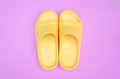 Beautiful yellow sandal on pink pastel background with copy space