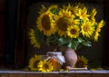 beautiful yellow Sunflower still life bouquet in a clay jug ceramic rustic style oil honey Dark photo background wooden table Royalty Free Stock Photo